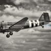 Black and white C-47 Dakota Black and white C47 Dakota wearing D Day invasion stripes. Side view of aeroplane as it lands