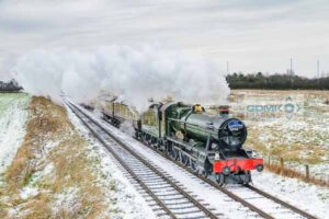 Hall class 4-6-0 Witherslack Hall steam train heading through the snowy Leicestershire countryside on the Great Central Railway