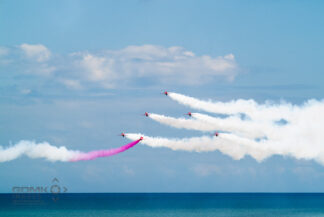 RAF Red Arrows aerobatic display team flying over the sea