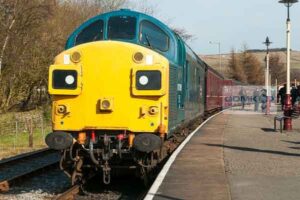 Class 37 loco in BR Blue colour scheme at the front of a passenger train on the East Lancs Railway