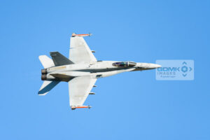 Top side view of a Finnish F-18 aircraft in a tight turn during an airshow display