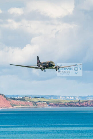 WW2 C-47 Dakota airplane flying low over the Devon Coast