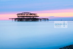 The derelict remains of Brighton West pier against the pastel colours of evening light