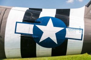 Black and white D Day invasion stripes on the fuselage of a C47 Dakota troop carrying aeroplane