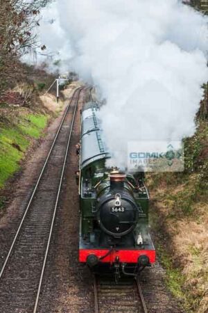 Looking down onto Great Western Railway 0-6-2T steam loco heading a passenger train on the Great Central Railway