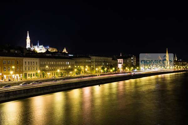 Night time reflections on the Danube Matthias Church overlooking the reflections of the streets below in the River Danube in Budapest at night