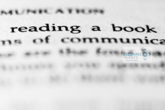 Closeup of text saying 'reading a book' in a paperback book