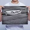 Man Holding Black and White Boat on a Beach Wall Art Print Man Holding Black and White Boat on a Beach Wall Art Print