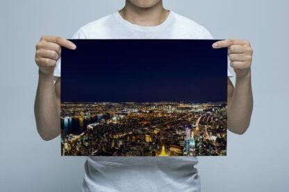 Man Holding City lights of New York at night Wall Art Print