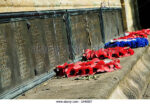 wreaths-of-poppies-laid-next-to-names-of-fallen-soldiers-at-the-foot-DH6557