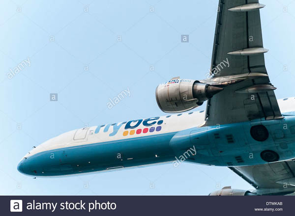 Underneath view of a Flybe Embraer short haul aeroplane flying directly overhead