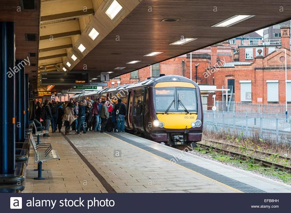 Passengers waiting to get onto a Cross Country regional passenger train at Leicester railway station