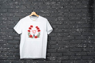 White t-shirt hanging on hanger against brick wall